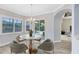 Bright dining area with a modern chandelier, round table, and sliding glass doors overlooking the pool at 5509 Meadow Hill Loop, Lady Lake, FL 32159