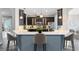 Kitchen featuring a bar-height island with pendant lighting, dark cabinets, and stainless steel appliances at 5509 Meadow Hill Loop, Lady Lake, FL 32159