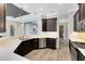 Spacious kitchen featuring dark wood cabinets, stainless steel appliances, and large quartz countertops at 5509 Meadow Hill Loop, Lady Lake, FL 32159