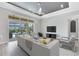Bright living room with tile floors, a ceiling fan, and sliding glass doors to the outdoor pool area at 5509 Meadow Hill Loop, Lady Lake, FL 32159