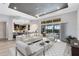 Open-concept living room featuring a dark tray ceiling, tile flooring, and sliders to the pool at 5509 Meadow Hill Loop, Lady Lake, FL 32159
