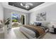 Serene main bedroom with a ceiling fan and sliding glass doors to a screened pool area at 5509 Meadow Hill Loop, Lady Lake, FL 32159