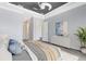 Bright main bedroom with a gray accent wall, modern decor, and an ensuite bathroom at 5509 Meadow Hill Loop, Lady Lake, FL 32159