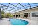 Inviting outdoor space with a screened-in pool, spa, and patio, perfect for year-round enjoyment at 5509 Meadow Hill Loop, Lady Lake, FL 32159