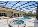 Private backyard featuring a large screened-in pool, spa, and plenty of space for outdoor enjoyment at 5509 Meadow Hill Loop, Lady Lake, FL 32159