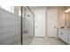 Contemporary bathroom features a glass-enclosed shower with stylish gray tile and modern fixtures at 557 Moon Shell Cir, New Smyrna Beach, FL 32168