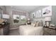 Bright bedroom featuring large windows, stylish decor, and neutral tones at 557 Moon Shell Cir, New Smyrna Beach, FL 32168