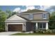 Charming two-story home featuring a two-car garage and classic architectural details at 557 Moon Shell Cir, New Smyrna Beach, FL 32168