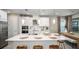 Bright kitchen featuring an island with seating, pendant lighting, and stainless steel appliances at 557 Moon Shell Cir, New Smyrna Beach, FL 32168