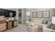 Cozy living room featuring a comfortable sectional sofa, TV, and stylish decor at 557 Moon Shell Cir, New Smyrna Beach, FL 32168
