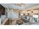 Open-concept living room with a view of the staircase, kitchen, and contemporary decor at 557 Moon Shell Cir, New Smyrna Beach, FL 32168
