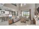 Cozy living room featuring high ceilings, comfortable seating, and access to the backyard at 557 Moon Shell Cir, New Smyrna Beach, FL 32168