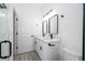 Bright bathroom with double sinks, modern fixtures, and a door to the shower/toilet room at 6872 Sw 132Nd Pl, Ocala, FL 34473