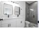 Modern bathroom featuring double sinks, black fixtures, and a sleek glass-enclosed shower at 6872 Sw 132Nd Pl, Ocala, FL 34473