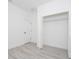 Well-lit bedroom with a closet and light wood-look flooring creates a modern and inviting space at 6872 Sw 132Nd Pl, Ocala, FL 34473