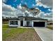 Beautiful single-story home with a well-maintained lawn and a long driveway leading to the garage at 6872 Sw 132Nd Pl, Ocala, FL 34473