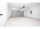 Spacious garage with ample room for parking and storage, featuring a gray garage door at 6872 Sw 132Nd Pl, Ocala, FL 34473