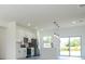 Open concept kitchen with island, stainless steel appliances, recessed lighting, and sliding glass doors at 6872 Sw 132Nd Pl, Ocala, FL 34473