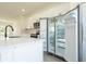 Bright kitchen features white cabinets, stainless steel appliances, and a large island with quartz countertops at 6872 Sw 132Nd Pl, Ocala, FL 34473