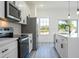 Contemporary kitchen featuring a range, stainless steel refrigerator, and a sink with a window view at 6872 Sw 132Nd Pl, Ocala, FL 34473