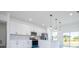 Modern kitchen featuring white cabinets, quartz countertops, stainless steel appliances, and pendant lights at 6872 Sw 132Nd Pl, Ocala, FL 34473