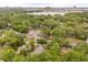 Aerial view of a neighborhood with tree coverage and a lake in the distance at 730 Cordova Dr, Orlando, FL 32804