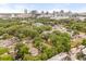 Aerial view of the neighborhood showing homes among mature trees with the city skyline in the distance at 730 Cordova Dr, Orlando, FL 32804
