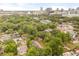 Aerial view of the neighborhood with mature trees, houses, and skyline in the background at 730 Cordova Dr, Orlando, FL 32804