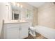 Bathroom with a tub, updated tiling, and a large mirror above the sink at 730 Cordova Dr, Orlando, FL 32804