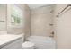 Bright bathroom featuring a shower over tub with tiled walls and a window at 730 Cordova Dr, Orlando, FL 32804
