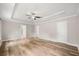 Large bedroom with tray ceilings, wood flooring, neutral paint, and doorways to other areas at 730 Cordova Dr, Orlando, FL 32804