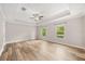 Spacious bedroom with tray ceiling, wood floors, and large windows allowing ample natural light at 730 Cordova Dr, Orlando, FL 32804