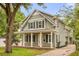 Charming two-story home featuring a cozy front porch with brick pavers and white columns at 730 Cordova Dr, Orlando, FL 32804