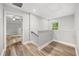 Hallway with hardwood floors that leads to multiple rooms and a window at 730 Cordova Dr, Orlando, FL 32804