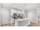 Modern kitchen with stainless steel appliances, white cabinets, island, and ample natural light at 730 Cordova Dr, Orlando, FL 32804