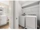 Laundry room with white front-load washer and dryer next to a bathroom at 730 Cordova Dr, Orlando, FL 32804