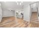 Open-concept living space featuring wood floors, staircase and connecting kitchen with an island at 730 Cordova Dr, Orlando, FL 32804