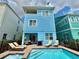 Home backyard featuring a private pool, spa, patio seating and lounge chairs at 7968 Shaker St, Kissimmee, FL 34747