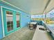 Outdoor balcony featuring an outdoor kitchen, table and chairs overlooking the lake at 7968 Shaker St, Kissimmee, FL 34747