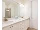 Well-lit bathroom with double vanities, granite countertops, and a glass shower at 7968 Shaker St, Kissimmee, FL 34747
