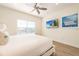 Relaxing bedroom featuring a TV, a window with blinds, and cozy lighting at 7968 Shaker St, Kissimmee, FL 34747