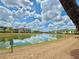 Beautiful community with a long lake reflecting the clouds and sky, and colorful homes along the waterfront at 7968 Shaker St, Kissimmee, FL 34747