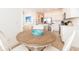 Dining area with a round table and chairs, adjacent to the kitchen and breakfast bar at 7968 Shaker St, Kissimmee, FL 34747
