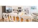 Island kitchen with white cabinetry, stainless steel appliances, and barstool seating at 7968 Shaker St, Kissimmee, FL 34747
