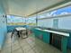 Outdoor patio featuring a built-in kitchen, dining table, and beautiful views at 7968 Shaker St, Kissimmee, FL 34747