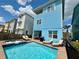 Exterior of home with a private pool, spa, patio seating, and lounge chairs at 7968 Shaker St, Kissimmee, FL 34747