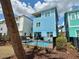 Backyard view of a charming two-story blue home with a private pool and patio furniture at 7968 Shaker St, Kissimmee, FL 34747