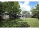 Spacious backyard with lush green grass, enclosed pool, and a convenient storage shed at 854 Escabar Dr, Altamonte Springs, FL 32714