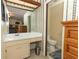 Bathroom with a sink vanity and toilet and mirror reflecting into the main bedroom at 854 Escabar Dr, Altamonte Springs, FL 32714