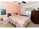 Cozy bedroom with a comfortable bed, ceiling fan, windows and a dark wood dresser at 854 Escabar Dr, Altamonte Springs, FL 32714